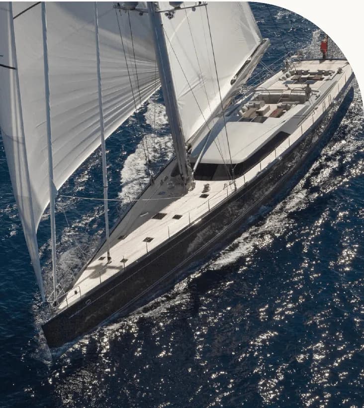 A sailing superyacht under full sail, seen from above